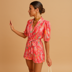 Women’s short summer jumpsuit with waist belt and colorful print, perfect for warm days, weekend fun, or summer evenings.